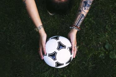 soccer-ball-in-hands-on-grass_373x.jpg
